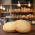 Two round zeera biscuits with cumin seeds on a wooden surface